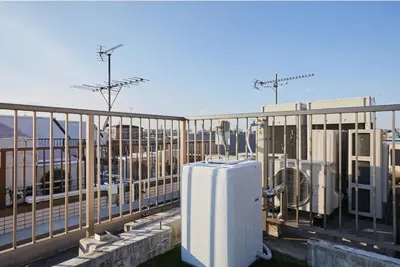 a white refrigerator sitting on top of a balcony at Kyodo Private House in Tokyo