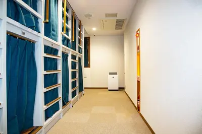 a corridor of a hallway with blue and white walls at Guest House Siesta in Tokyo