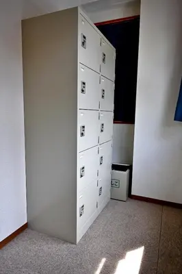 a room with a wall with a bunch of boxes at Guest House Siesta in Tokyo
