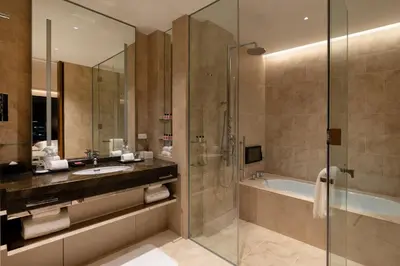 a bathroom with a shower and a sink and a tub at The Okura Tokyo in Tokyo