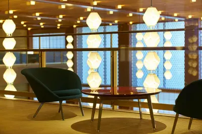 a room with a table and two chairs and a window at The Okura Tokyo in Tokyo