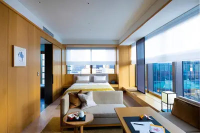 a living room with a bed and a couch at The Okura Tokyo in Tokyo