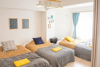a bedroom with two beds and a window at LY INN Ryogoku Annex in Tokyo