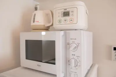 a white microwave sitting on top of a counter at LY INN Ryogoku Annex in Tokyo
