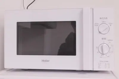 a white microwave oven sitting on top of a counter at LY INN Ryogoku Annex in Tokyo