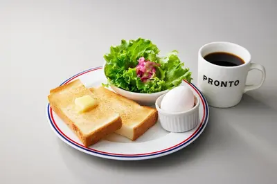 a plate with toast and a salad and a cup of coffee at Sotetsu Fresa Inn Nihombashi Kayabacho in Tokyo