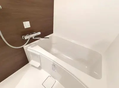 a white bath tub in a bathroom with a sink at LANG Hotel GINZA 1K in Tokyo