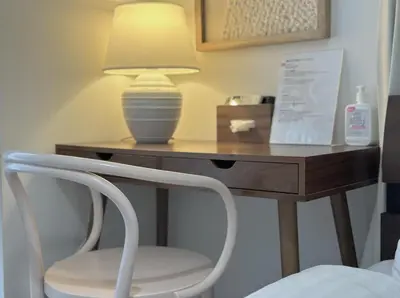 a desk with a lamp and a white chair at LANG Hotel GINZA 1K in Tokyo