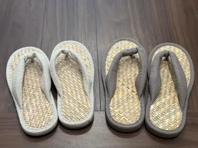 two pairs of shoes on a wooden floor at LANG Hotel GINZA 1K in Tokyo