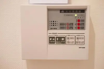 a white microwave oven sitting on top of a wall at T-home1 2F in Tokyo