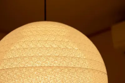 a close up of a white lamp shade at T-home1 2F in Tokyo