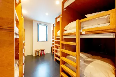 a dorm room with bunk beds in it at plat hostel keikyu asakusa karin in Tokyo