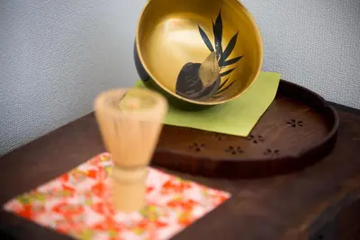 a wooden table with a gold helmet on a table at plat hostel keikyu asakusa karin in Tokyo