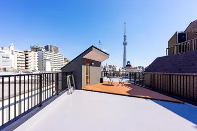 a rooftop deck with a view of the city at plat hostel keikyu asakusa karin in Tokyo