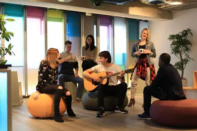 a group of people sitting in a room with instruments at UNPLAN Shinjuku in Tokyo