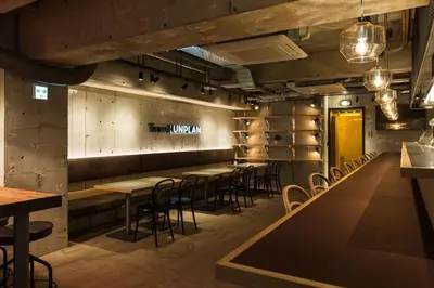 a row of tables and chairs in a restaurant at UNPLAN Shinjuku in Tokyo