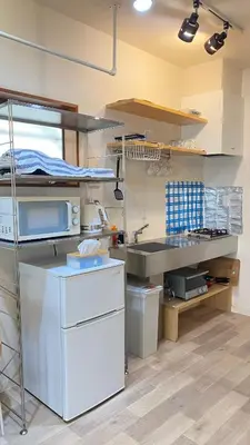 a kitchen with a bunk bed in a room at Den 7 in Tokyo