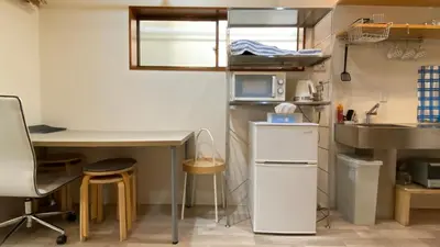a small kitchen with a desk and a sink at Den 7 in Tokyo