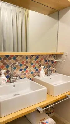 a bathroom with a sink and a mirror at Den 7 in Tokyo