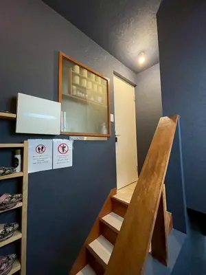 a room with a staircase with a window and a door at Den 7 in Tokyo