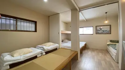 a room with two beds and a table at Den 7 in Tokyo