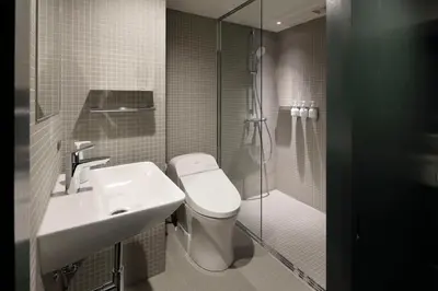 a bathroom with a toilet and a sink and a shower at DDD HOTEL in Tokyo