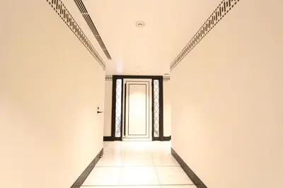 an empty corridor with a door in a white wall at KOKO HOTEL Premier Nihonbashi Hamacho in Tokyo