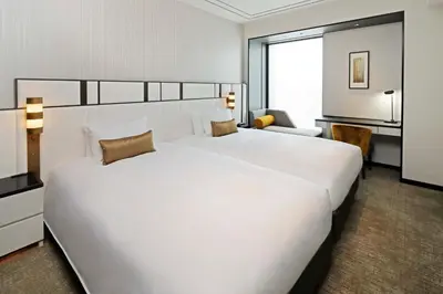 a large white bed in a hotel room at KOKO HOTEL Premier Nihonbashi Hamacho in Tokyo