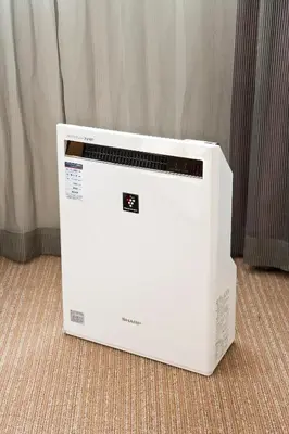 a white microwave oven sitting on the floor at Sotetsu Fresa Inn Shimbashi Hibiyaguchi in Tokyo