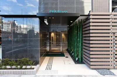 an entrance to a building with a glass facade at Sotetsu Fresa Inn Shimbashi Hibiyaguchi in Tokyo