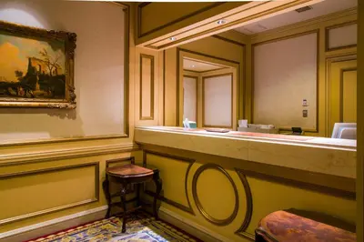 a bathroom with a vanity with a mirror and a stool at Rihga Royal Hotel Tokyo in Tokyo