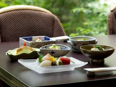 a table with bowls and plates of food on it at Rihga Royal Hotel Tokyo in Tokyo