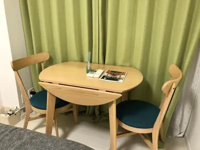 a wooden table with two chairs and a table with a book at \u30ea\u30d6\u30b7\u30c6\u30a3\u9326\u7cf8\u753a\u53c2\u756a\u9928\u4e0a\u5c64\u968e\u773a\u671b\u826f\u597d\u5317\u6b27\u30eb\u30fc\u30e0, Akihabara 6mins, Tokyo 8 mins, Direct to Narita Airport \u6210\u7530\u7a7a\u6e2f\u76f4\u9054 in Tokyo