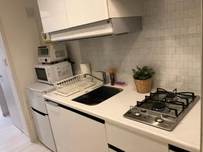 a kitchen with a sink and a stove top oven at \u30ea\u30d6\u30b7\u30c6\u30a3\u9326\u7cf8\u753a\u53c2\u756a\u9928\u4e0a\u5c64\u968e\u773a\u671b\u826f\u597d\u5317\u6b27\u30eb\u30fc\u30e0, Akihabara 6mins, Tokyo 8 mins, Direct to Narita Airport \u6210\u7530\u7a7a\u6e2f\u76f4\u9054 in Tokyo