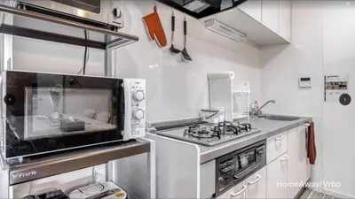 a kitchen with a stove and a microwave at V.Close to Shinjuku Kabukicho/Korean Town/FrWIFI C in Tokyo