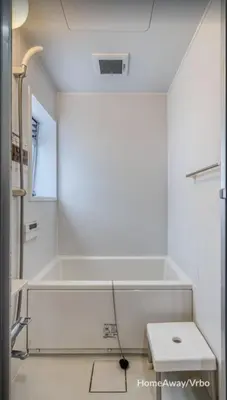 a white bathroom with a tub and a toilet at V.Close to Shinjuku Kabukicho/Korean Town/FrWIFI C in Tokyo