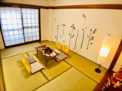 a living room with a table and chairs and a wall with flowers at V.Close to Shinjuku Kabukicho/Korean Town/FrWIFI C in Tokyo