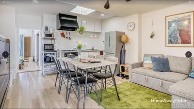 a kitchen and living room with a table and a couch at V.Close to Shinjuku Kabukicho/Korean Town/FrWIFI C in Tokyo