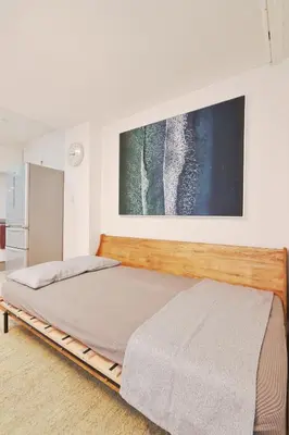 a bed with a wooden frame in a room at V.Close to Shinjuku Kabukicho/Korean Town/FrWIFI C in Tokyo