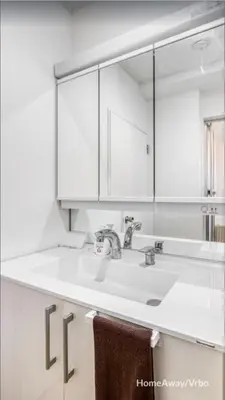 a white bathroom with a sink and a mirror at V.Close to Shinjuku Kabukicho/Korean Town/FrWIFI C in Tokyo