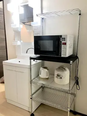a microwave sitting on a shelf with a kitchen appliance at Alo BnB 3 - Near KOMAGOME, IKEBUKURO, SHINJUKU, UENO - MAX 16 PAX in Tokyo