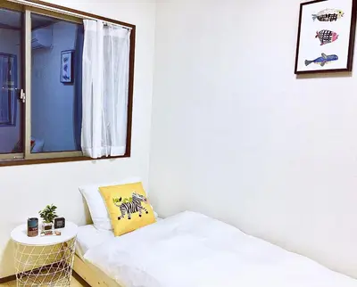 a small room with a bed and a mirror at Alo BnB 3 - Near KOMAGOME, IKEBUKURO, SHINJUKU, UENO - MAX 16 PAX in Tokyo