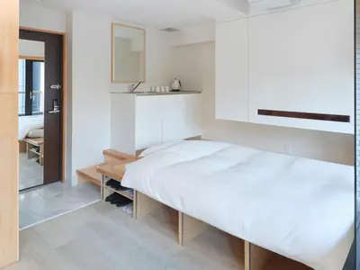 a bedroom with a large bed and a sink at Sakura Cross Hotel Akihabara in Tokyo