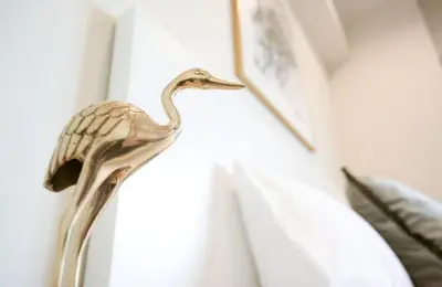 a statue of a bird on a window sill at Dash Living Tsukiji in Tokyo