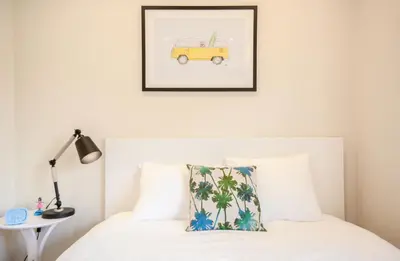 a bedroom with a bed with a picture of a yellow van at Dash Living Tsukiji in Tokyo