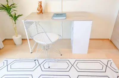 a desk with a chair in a room with a rug at Dash Living Tsukiji in Tokyo
