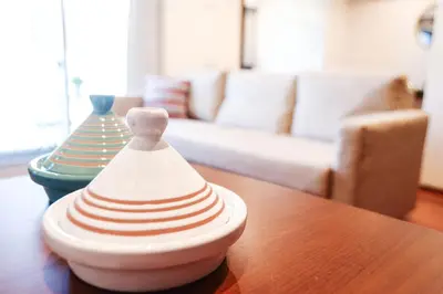 a white vase sitting on a table in a living room at Dash Living Tsukiji in Tokyo