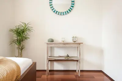 a bedroom with a table and a mirror at Dash Living Tsukiji in Tokyo