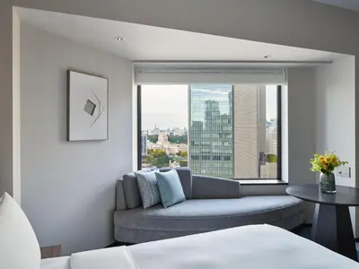a living room with a couch and a large window at ANA InterContinental Tokyo by IHG in Tokyo