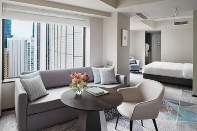 a living room with a couch and a table and a bed at ANA InterContinental Tokyo by IHG in Tokyo